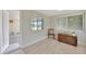 Clean bedroom with light wood floors and neutral gray walls at 1408 Dartmouth Dr, Holiday, FL 34691