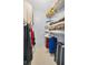 Walk-in closet featuring built-in shelving and plenty of storage space for clothing at 1408 Dartmouth Dr, Holiday, FL 34691