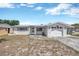 Charming single-story home featuring a classic design and a well-maintained front yard in a quiet neighborhood at 1408 Dartmouth Dr, Holiday, FL 34691