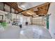 Spacious garage with laundry machines, utility sink, and exposed wood rafters at 1408 Dartmouth Dr, Holiday, FL 34691