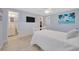 Serene main bedroom featuring light blue walls, a cozy bed, and an ensuite bathroom for added privacy at 1408 Dartmouth Dr, Holiday, FL 34691