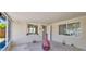 Neutral sun room with outdoor views and neutral flooring at 1408 Dartmouth Dr, Holiday, FL 34691