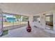 Enclosed sun room with an outdoor view, neutral paint, and neutral flooring at 1408 Dartmouth Dr, Holiday, FL 34691