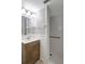 Bathroom features a vanity with sink, toilet, and walk-in shower with safety bar at 1516 Roundtree Rd, Holiday, FL 34690