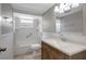 Renovated bathroom featuring a modern vanity with a white countertop, a tub, and tiled flooring at 1516 Roundtree Rd, Holiday, FL 34690