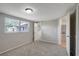 Bedroom with large window and plush gray carpeting plus easy access to bathroom at 1516 Roundtree Rd, Holiday, FL 34690