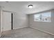 Bright bedroom with gray walls, carpeted flooring, and a window offering natural light at 1516 Roundtree Rd, Holiday, FL 34690