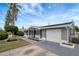 Charming single-story home featuring a one-car garage, decorative support columns, and landscaping at 1516 Roundtree Rd, Holiday, FL 34690