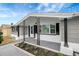 Cozy front porch featuring decorative support columns, modern lighting and landscape at 1516 Roundtree Rd, Holiday, FL 34690