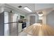 Updated kitchen with modern stainless-steel appliances, wood countertops and neutral toned cabinetry at 1516 Roundtree Rd, Holiday, FL 34690