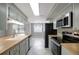 Updated kitchen with modern stainless-steel appliances, wood countertops and neutral toned cabinetry at 1516 Roundtree Rd, Holiday, FL 34690