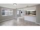 Kitchen with stainless steel refrigerator, breakfast bar open to dining area with big windows at 1516 Roundtree Rd, Holiday, FL 34690