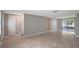Spacious living room with neutral walls and tile flooring, perfect for entertaining at 1516 Roundtree Rd, Holiday, FL 34690