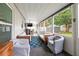 Enclosed porch with comfortable seating and a mounted television for outdoor entertainment at 1529 79Th N Ave, St Petersburg, FL 33702