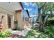 Landscaped backyard with a brick pathway leading to a screened-in pool area at 15724 Ibisridge Dr, Lithia, FL 33547