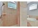 Bright bathroom featuring a glass-enclosed shower and a soaking tub under a window at 15724 Ibisridge Dr, Lithia, FL 33547