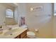 Cozy powder room featuring modern fixtures, neutral tones, and decorative wall art at 15724 Ibisridge Dr, Lithia, FL 33547