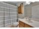 Well-lit bathroom featuring vanity with sink, toilet, and shower with curtain at 15724 Ibisridge Dr, Lithia, FL 33547