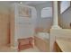 This bright bathroom features a soaking tub, framed art and a wooden bench seat at 15724 Ibisridge Dr, Lithia, FL 33547