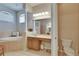 Bright bathroom featuring soaking tub, walk-in shower, and dual sinks at 15724 Ibisridge Dr, Lithia, FL 33547