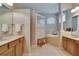 Light filled bathroom offering walk-in shower, tub, and dual sinks at 15724 Ibisridge Dr, Lithia, FL 33547