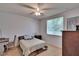 Comfortable bedroom featuring neutral walls, ceiling fan, and ample natural light at 15724 Ibisridge Dr, Lithia, FL 33547