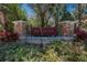 Entrance to Ibis Park featuring a brick and stone sign surrounded by lush landscaping at 15724 Ibisridge Dr, Lithia, FL 33547