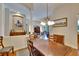 Dining room boasts elegant chandelier and views of the living room and lanai at 15724 Ibisridge Dr, Lithia, FL 33547
