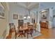 Dining room with hardwood floors, dining table with 6 chairs, and elegant decor at 15724 Ibisridge Dr, Lithia, FL 33547