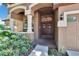 Inviting front entrance with double doors, decorative wreaths, and manicured landscaping at 15724 Ibisridge Dr, Lithia, FL 33547