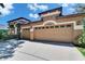 Three car garage with a lush lawn and blue skies at 15724 Ibisridge Dr, Lithia, FL 33547