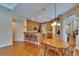Bright eat-in kitchen features wood floors, an island, and breakfast bar seating at 15724 Ibisridge Dr, Lithia, FL 33547