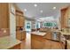 Kitchen with granite countertops and stainless appliances opens to the dining area and living room at 15724 Ibisridge Dr, Lithia, FL 33547