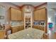 Kitchen features an island, granite counters, wood cabinets, and walk-in pantry at 15724 Ibisridge Dr, Lithia, FL 33547