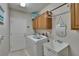 Functional laundry room features a washer, dryer, utility sink, and built-in cabinets at 15724 Ibisridge Dr, Lithia, FL 33547