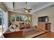 Spacious living room features hardwood floors, a cozy sofa, and an entertainment center at 15724 Ibisridge Dr, Lithia, FL 33547