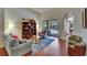 Bright living room with hardwood floors, comfortable seating, and sliding glass doors to the patio at 15724 Ibisridge Dr, Lithia, FL 33547