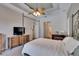 Spacious main bedroom with ceiling fan, ensuite, and tv at 15724 Ibisridge Dr, Lithia, FL 33547