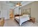 Large main bedroom boasts carpet, ceiling fan, and ensuite bathroom at 15724 Ibisridge Dr, Lithia, FL 33547