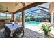 Relaxing screened-in patio offers covered dining and a private pool and spa at 15724 Ibisridge Dr, Lithia, FL 33547