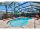 Sparkling screened-in pool with attached spa, beautiful landscaping and lounge area at 15724 Ibisridge Dr, Lithia, FL 33547
