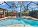 Private screened-in pool and spa surrounded by lush landscaping and brick pavers at 15724 Ibisridge Dr, Lithia, FL 33547