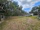 Expansive backyard showcasing a horse barn and open space, perfect for outdoor activities and equestrian pursuits at 1641 Thompson Rd, Lithia, FL 33547