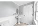 This bathroom contains a pedestal sink with traditional finishes at 1641 Thompson Rd, Lithia, FL 33547