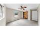 Neutral bedroom features a ceiling fan, window and a closet with shelving at 1641 Thompson Rd, Lithia, FL 33547
