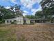 Single-story home featuring a large carport and a spacious yard, surrounded by mature trees offering ample shade at 1641 Thompson Rd, Lithia, FL 33547