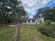 Charming single-story home featuring a bright exterior and a well-maintained yard surrounded by mature trees at 1641 Thompson Rd, Lithia, FL 33547
