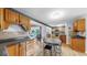 Kitchen featuring wood cabinets, black countertops, hardwood floors and an open view to the sunroom at 1641 Thompson Rd, Lithia, FL 33547
