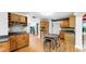 Kitchen featuring wood cabinets, black countertops, hardwood floors and an eat-in dining area at 1641 Thompson Rd, Lithia, FL 33547