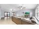 This is an open living room area with large tile floors and two ceiling fans at 1641 Thompson Rd, Lithia, FL 33547